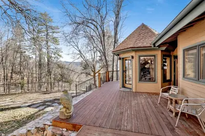 a house with a wooden deck with a owl statue on it at Big Bear 7th Heaven #714 in Fawnskin