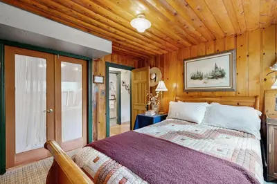 a bedroom with a bed and a wooden ceiling at Rooster's Den #710 in Big Bear Lake