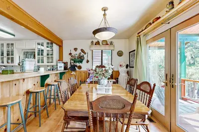 a dining room with a wooden table and chairs at Rooster's Den #710 in Big Bear Lake