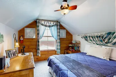 a bedroom with a bed and a ceiling fan at Rooster's Den #710 in Big Bear Lake