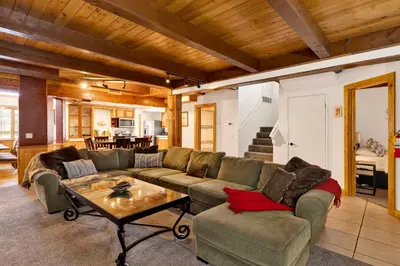 a living room with a couch and a table at Summit Hideaway #445 in Big Bear Lake