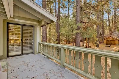 a porch of a house with a glass door at Summit Hideaway #445 in Big Bear Lake