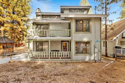a large white house with a balcony at Summit Hideaway #445 in Big Bear Lake