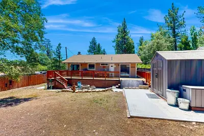 a house with a fence and a shed at Lazy Bear Cabin #554 in Big Bear Lake