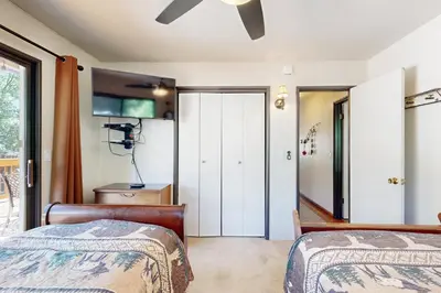 a bedroom with two beds and a ceiling fan at Lazy Bear Cabin #554 in Big Bear Lake
