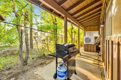 a grill on a screened porch of a house at Orchard Family Cabin #2560 in Big Bear Lake