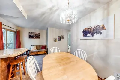 a dining room with a wooden table and chairs at Rosie's Hideaway #331 in Big Bear Lake