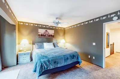 a bedroom with a bed and a ceiling fan at Rosie's Hideaway #331 in Big Bear Lake