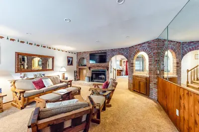a living room filled with furniture and a brick wall at Rosie's Hideaway #331 in Big Bear Lake