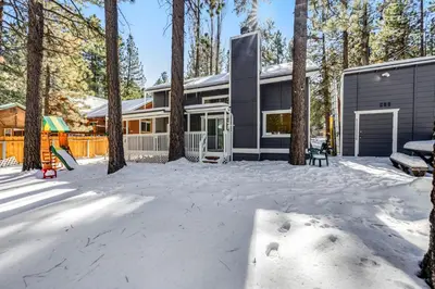a house in the snow with a playground at Moose-in' Around in Big Bear Lake