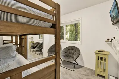 a bedroom with a bunk bed and a desk at Moose-in' Around in Big Bear Lake