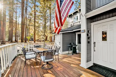 a deck with an american flag on a house at Moose-in' Around in Big Bear Lake