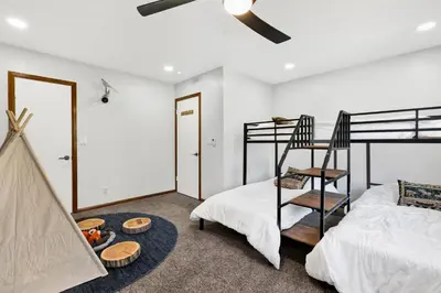a bedroom with a bunk bed and a bed and a table at The Fox Den #2568 in Big Bear City