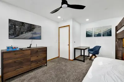 a bedroom with a ceiling fan and a desk at The Fox Den #2568 in Big Bear City
