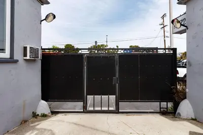 a black metal gate in a driveway at Cozy Studio Studio City Unit 6 in Los Angeles