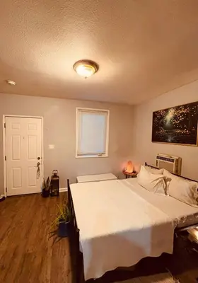 a bedroom with a large white bed and a window at Cozy Studio Studio City Unit 6 in Los Angeles