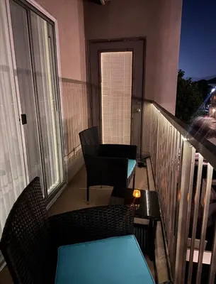 a balcony with chairs and a table on a balcony at Magic Splash Getaway in Santa Clarita