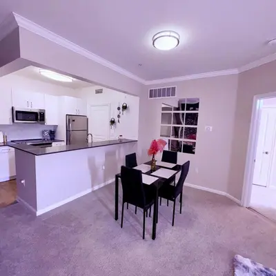 a kitchen and dining room with a table and chairs at Magic Splash Getaway in Santa Clarita