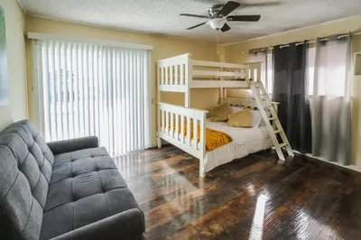 a bedroom with a bunk bed and a couch at Swinton in North Hills