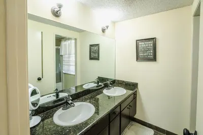 a bathroom with two sinks and a mirror at Swinton in North Hills