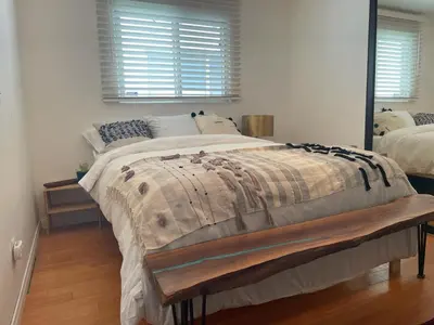 a bedroom with a large bed and a mirror at Cozy Beach Bungalow- Happynest in Long Beach