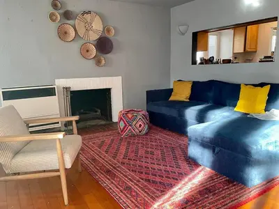 a living room with a blue couch and a fireplace at Cozy Beach Bungalow- Happynest in Long Beach