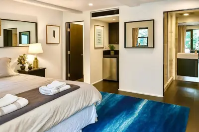 a bedroom with a large bed with towels on it at Chic Private Hollywood Hills Guest Suite Oasis with Tree-Top Views, Outdoor Living Room, Only 2 Minutes from Hollywood Boulevard in Los Angeles