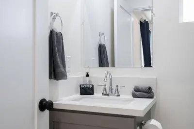 a bathroom with a sink and a mirror at Sunset Chateau Hollywood in Los Angeles