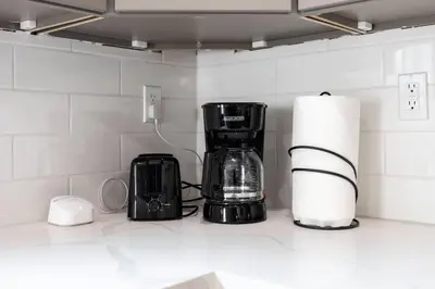 a kitchen counter with a coffee maker and a toaster at Sunset Chateau Hollywood in Los Angeles