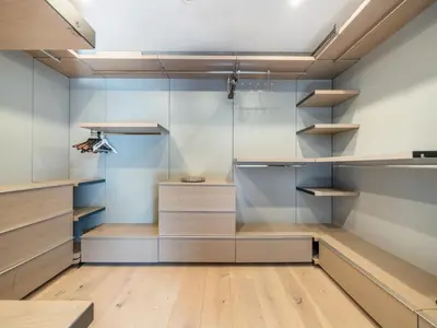 a walk in closet with wooden floors and shelves at Sycamore Villa in Los Angeles