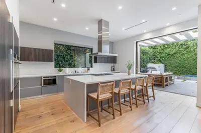 a kitchen with a island with bar stools at Laurel K Villa in Los Angeles