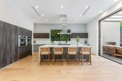 a kitchen with a large island with bar stools at Laurel K Villa in Los Angeles