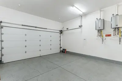 an empty garage with white walls and doors at Laurel K Villa in Los Angeles