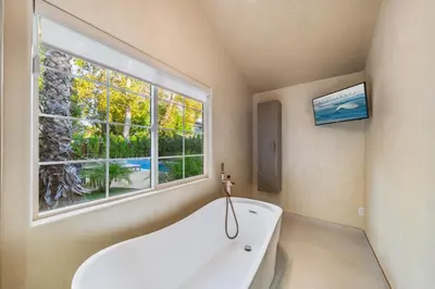 a white bath tub in a bathroom with a window at Fulton Villa in Garnsey