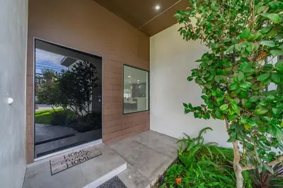 a house entrance with a large window and a tree at Fulton Villa in Garnsey