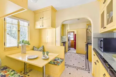 a small kitchen with a table and a counter top at Welcome to The Spanish Hideaway! in Los Angeles