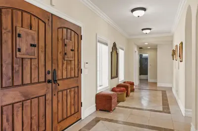 a hallway with a large wooden door and chairs at City View Rancho Palos Verdes Home in Rancho Palos Verdes