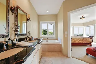 a bathroom with two sinks and a bed and a tub at City View Rancho Palos Verdes Home in Rancho Palos Verdes