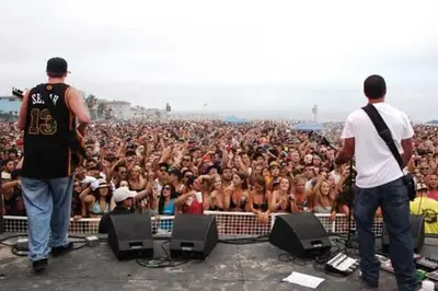 two men standing in front of a crowd of people at Awesome On The Strand, Hermosa Beach Property in Hermosa Beach