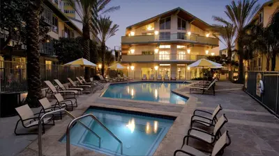 a swimming pool with chairs and a building at Top Floor Marina Escape 3BR Penthouse Ocean View in Los Angeles