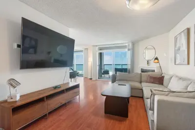 a living room with a couch and a large flat screen tv at Top Floor Marina Escape 3BR Penthouse Ocean View in Los Angeles