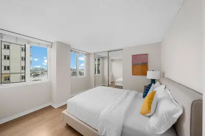 a white bedroom with a large bed and a window at Breezy & Beautiful - 3BR Marina del Rey Getaway in Los Angeles