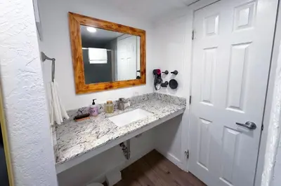 a bathroom with a sink and a mirror at Arrowhead Ranch Retreat and Conference Center in Lake Arrowhead