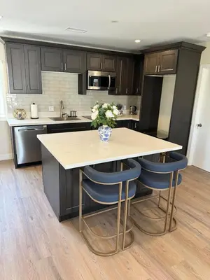 a kitchen with a table and some blue chairs at cozy & Elegant Torrance Apartment with balcony in Torrance
