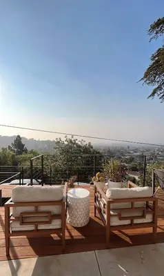 two chairs and a table on a deck with a view at Hillside Guest House with Sunset View in Los Angeles