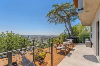 a balcony with a view of the city at Hillside Guest House with Sunset View in Los Angeles