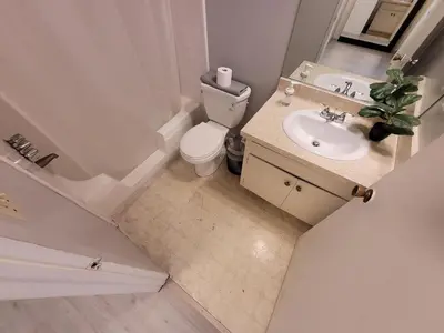 a bathroom with a toilet and a tub and a sink at Beverly Hills Nest in Los Angeles