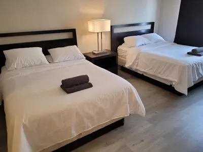 two beds in a hotel room with two beds sidx sidx sidx at Beverly Hills Nest in Los Angeles