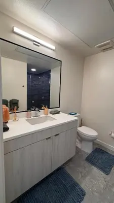a bathroom with a sink and a toilet and a mirror at Luxury Walk of Fame Studio in Los Angeles