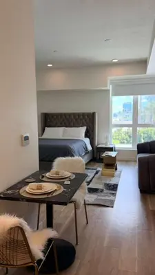 a living room with a bed and a table with plates on it at Luxury Walk of Fame Studio in Los Angeles